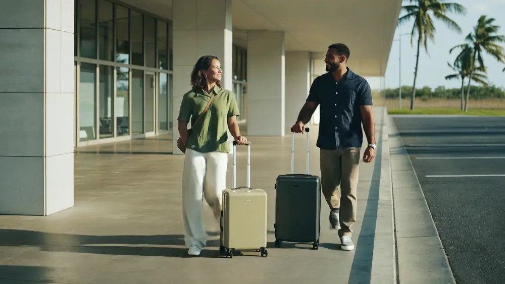 A couple arriving at Nassau airport with their bags